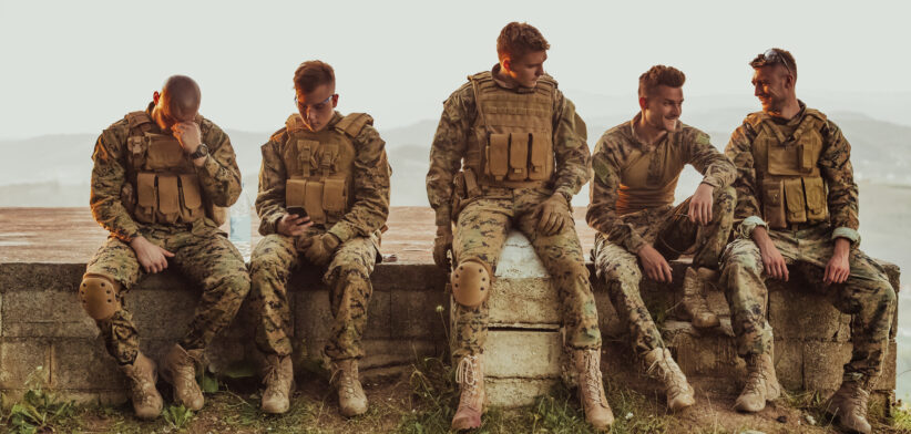 Soldiers squad relaxing after battle having a break on training