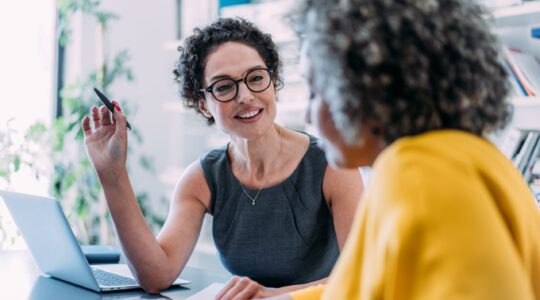 Woman providing advice to another woman.