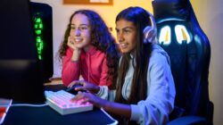 Teenage girls playing games online. | Newsreel