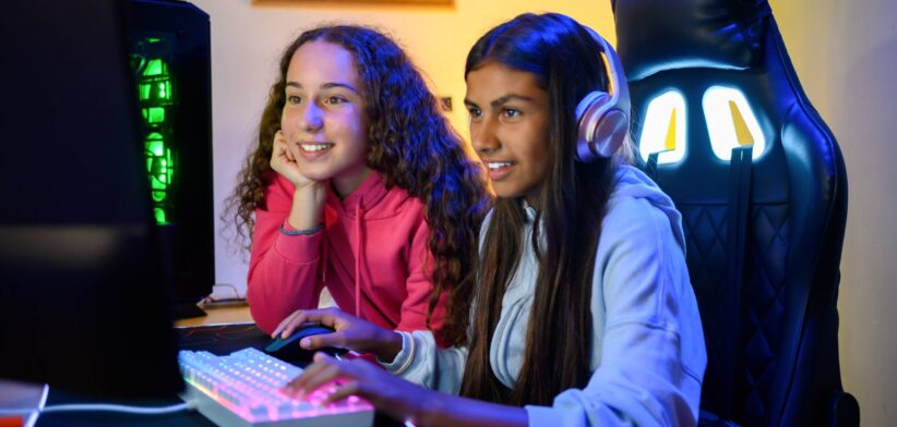 Teenage girls playing games online. | Newsreel