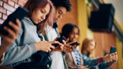 Teenagers on mobile phones. | Newsreel