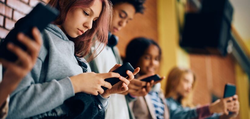 Teenagers on mobile phones. | Newsreel