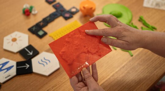 A model of Australia printed using the accessible guidelines including braille and raised contour lines.