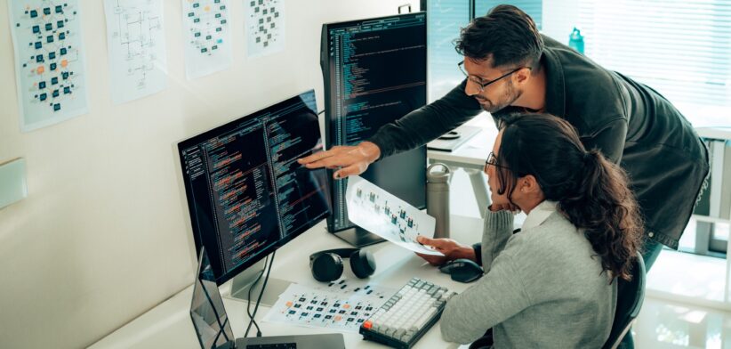 People looking at a computer program. | Newsreel