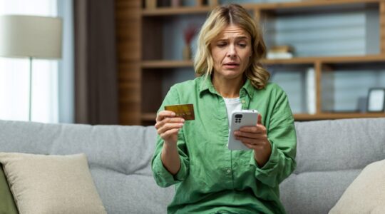 Woman worried about phone transaction.