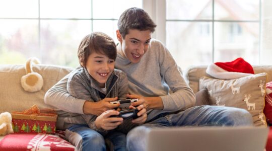 Two young brothers playing video games. | Newsreel