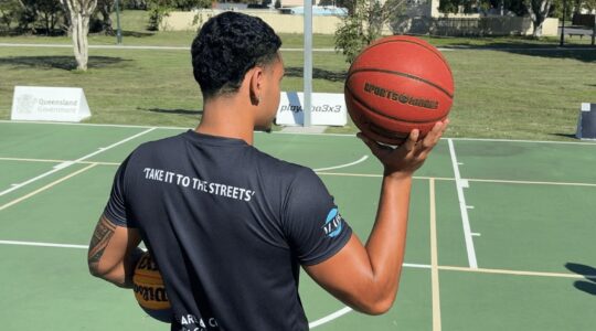 Man holding basketball. | Newsreel