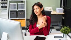 Woman with sore wrist at work. | Newsreel