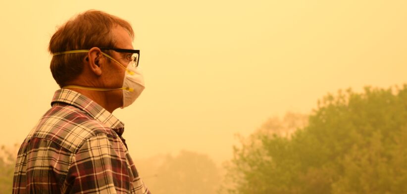 Man with mask and smoke from bushfire. | Newsreel