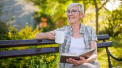 Elderly woman with book and coffee. | Newsreel