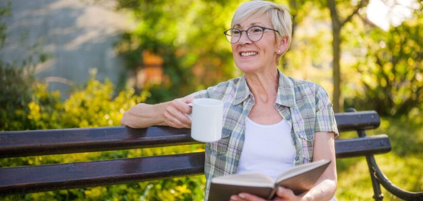 Elderly woman with book and coffee. | Newsreel