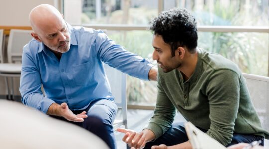 Man providing support to another man. | Newsreel