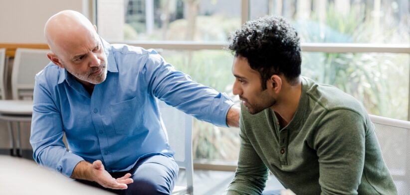 Man providing support to another man. | Newsreel