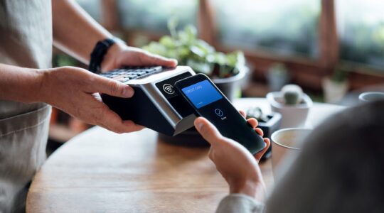 Shopper paying by mobile. | Newsreel