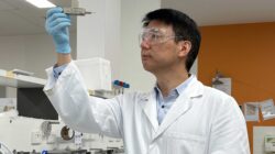 Professor Chuan Zhao holds up a prototype of a proton battery.