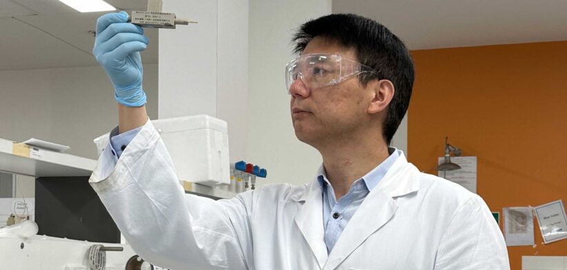 Professor Chuan Zhao holds up a prototype of a proton battery.