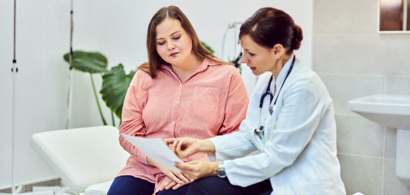 Overweight woman and doctor. | Newsreel