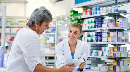 Pharmacist with customer at chemist. | Newsreel