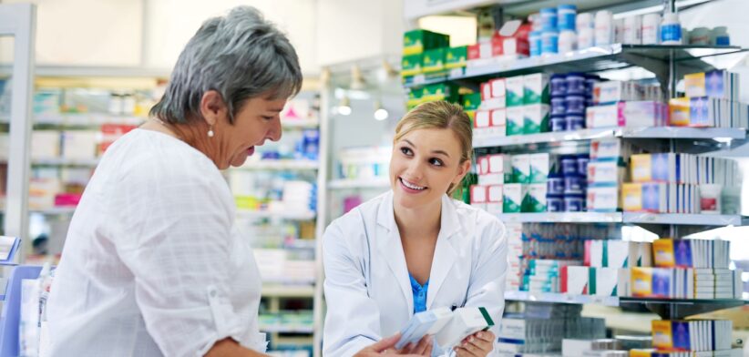 Pharmacist with customer at chemist. | Newsreel