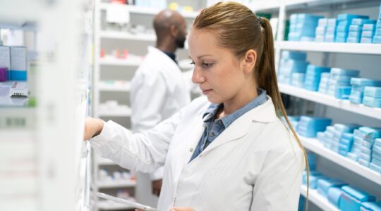 Pharmacist filling a prescription. | Newsreel