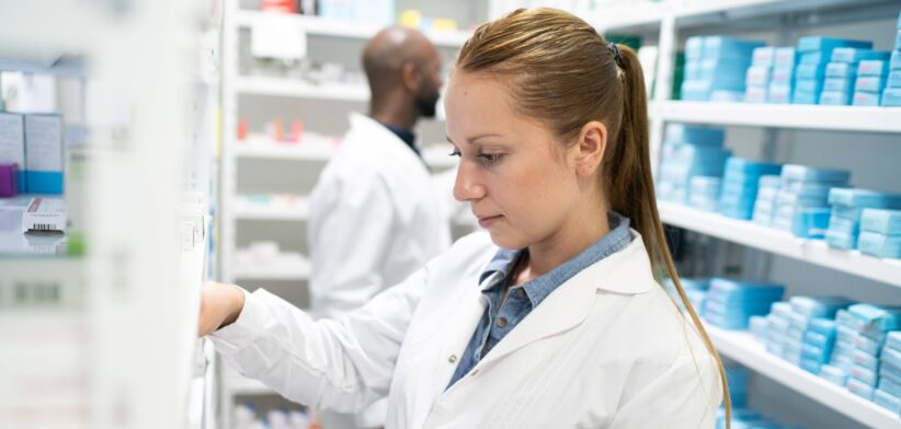 Pharmacist filling a prescription. | Newsreel