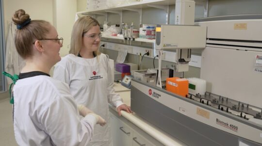 QIMR Berghofer researcher Dr Brittany Mitchell, right, and colleague. | Newsreel