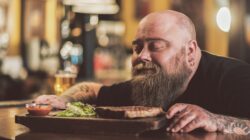 Man savouring steak meal. | Newsreel