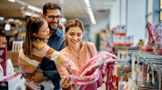 Family shopping for school backpack. | Newsreel