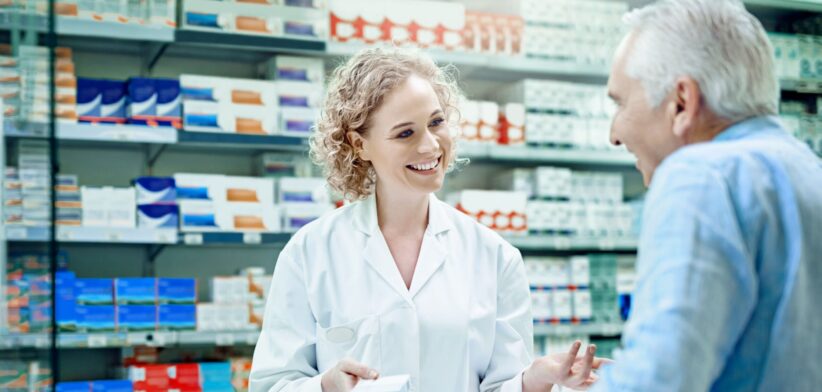 Chemist with elderly customer. | Newsreel