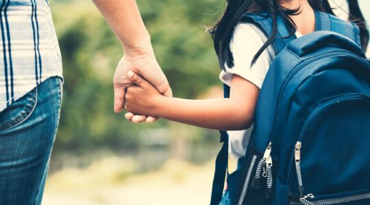 Adult and child hand in hand. | Newsreel