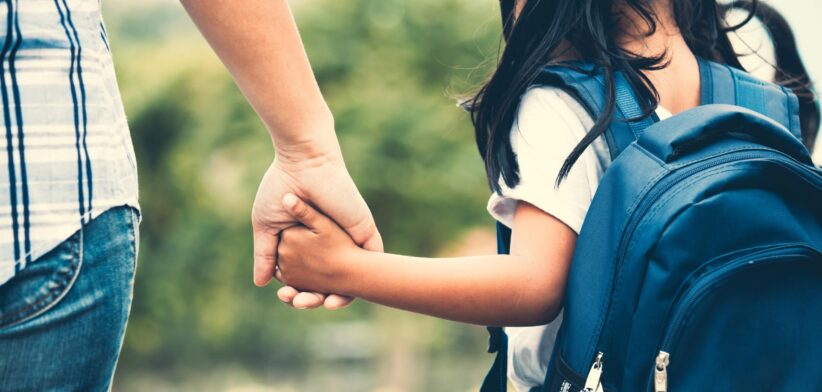 Adult and child hand in hand. | Newsreel