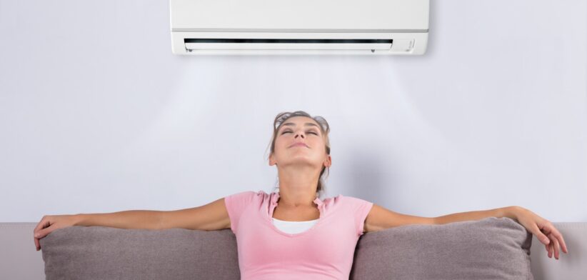 Woman under air conditioner. | Newsreel