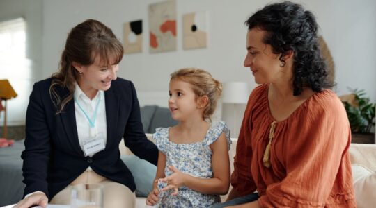 Support worker with mother and child. | Newsreel