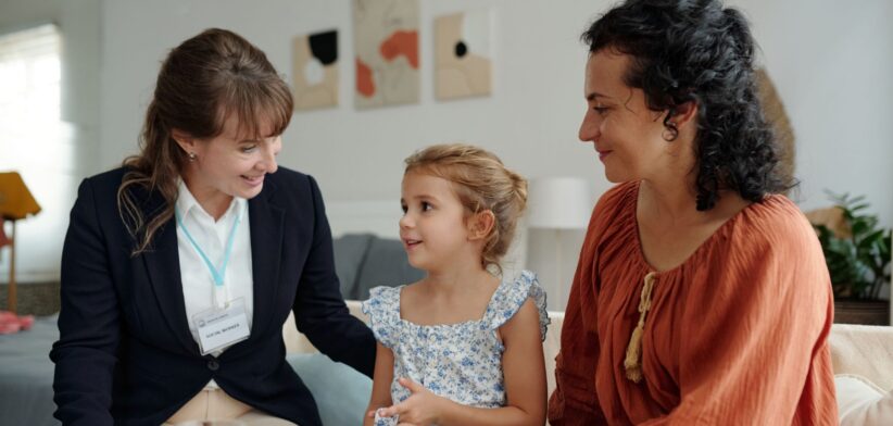 Support worker with mother and child. | Newsreel