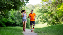 Portrait of happy fit people running together ourdoors. Couple sport healthy lifetsyle concept