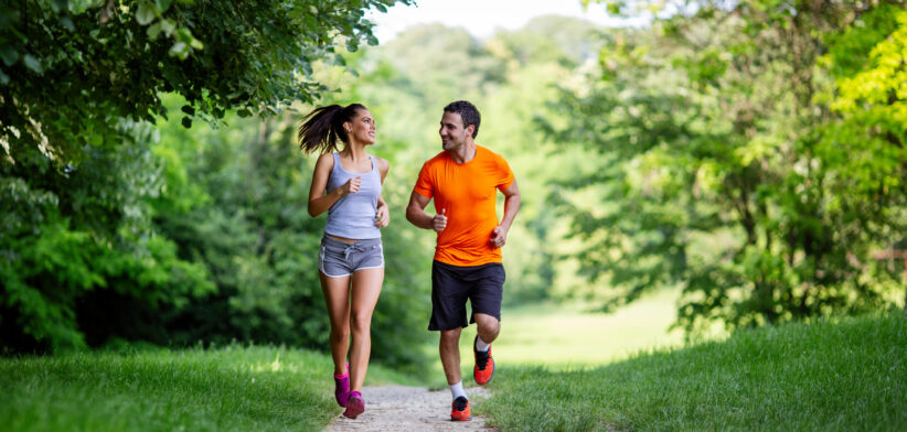 Portrait of happy fit people running together ourdoors. Couple sport healthy lifetsyle concept