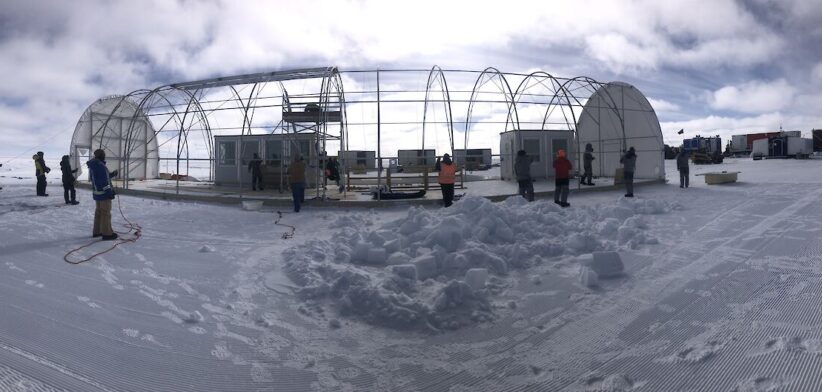 Australian Antarctic Program scientists prepare to pull the cover over the million year ice core drilling shelter. | Newsreel