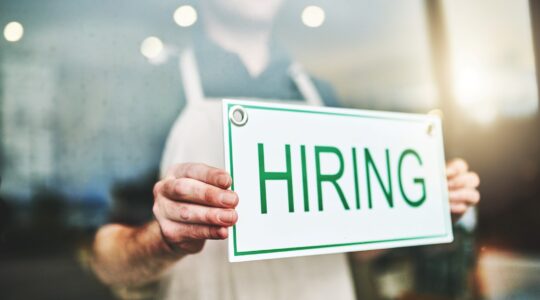 Employer with hiring sign. | Newsreel