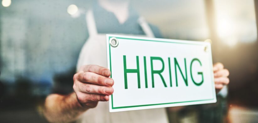 Employer with hiring sign. | Newsreel