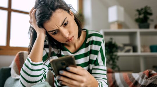 Woman worried looking at her phone. | Newsreel