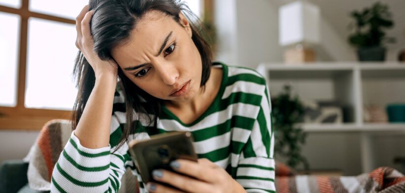 Woman worried looking at her phone. | Newsreel