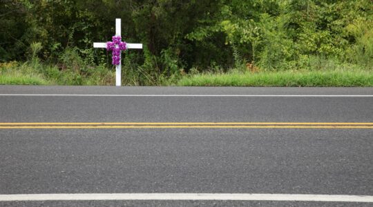 Cross by side of the road. | Newsreel