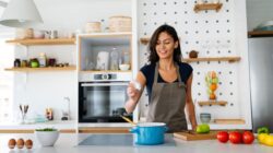 Woman adding salt to food. | Newsreel