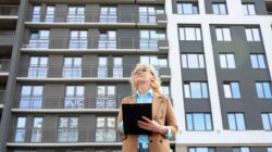 Woman outside block of units. | Newsreel