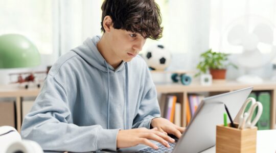 Student doing homework on computer. | Newsreel