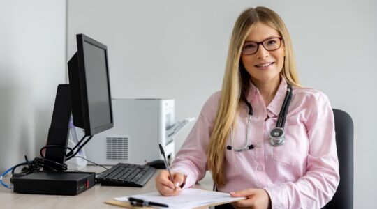 Doctor in her office. | Newsreel