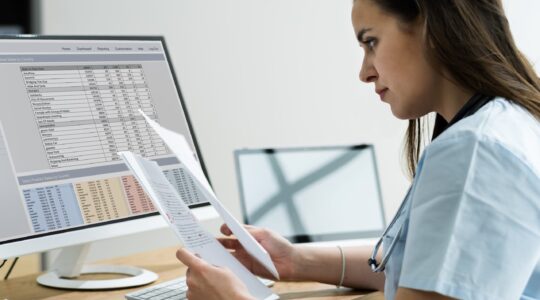 Doctor looking at health data. | Newsreel