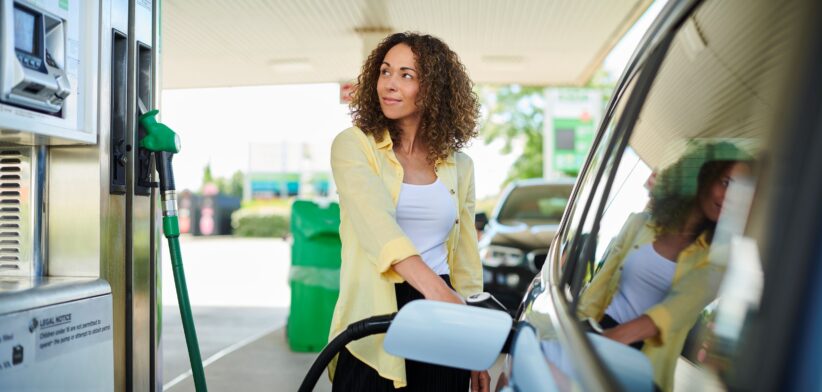 Woman filling up car with petrol. | Newsreel