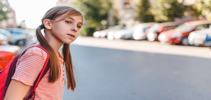 Young girl looking to cross road. | Newsreel