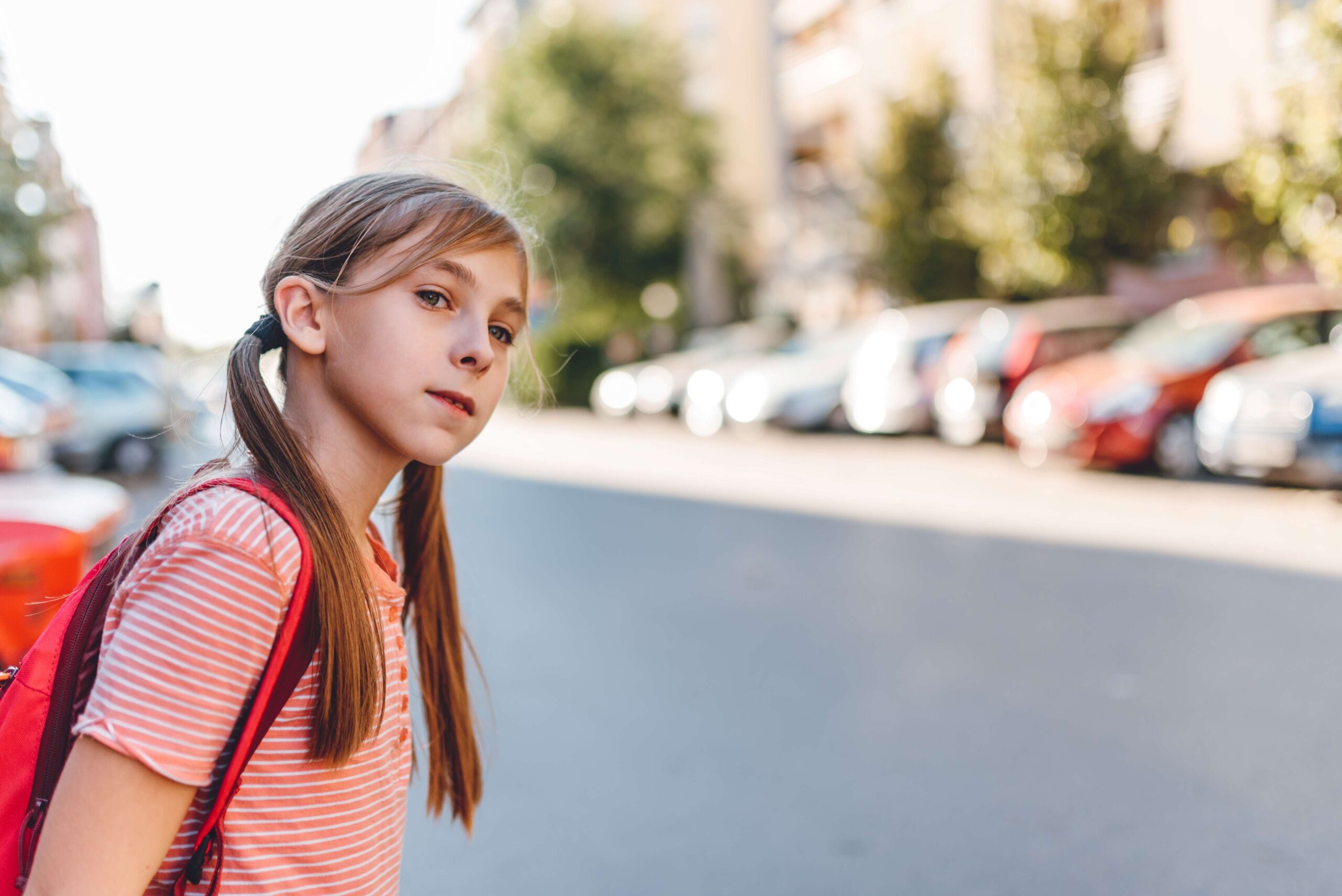 Young girl looking to cross road. | Newsreel